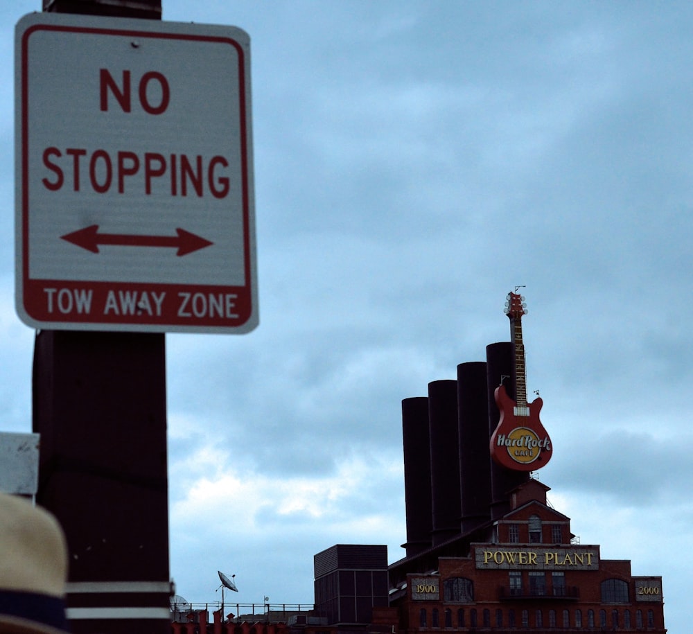 a sign with a building in the background