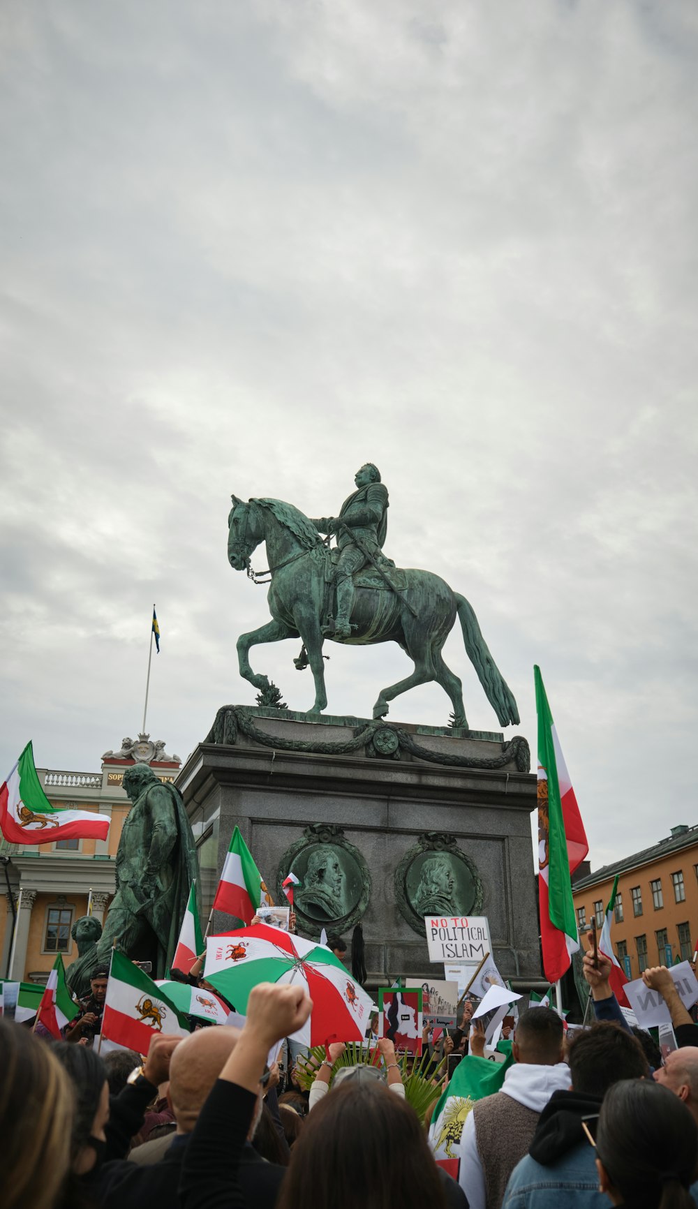 a crowd of people around a statue