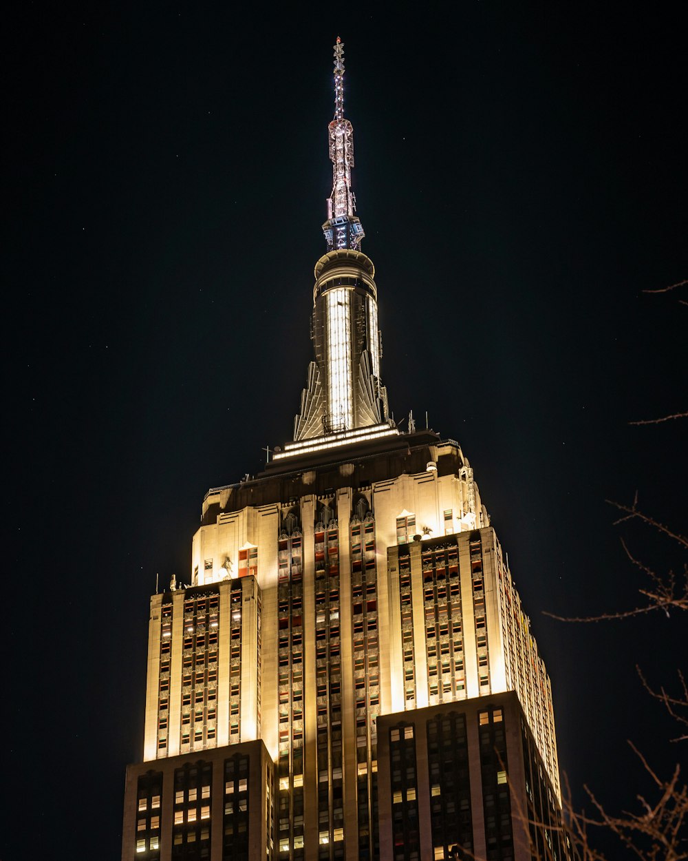 a tall building with a pointy top at night