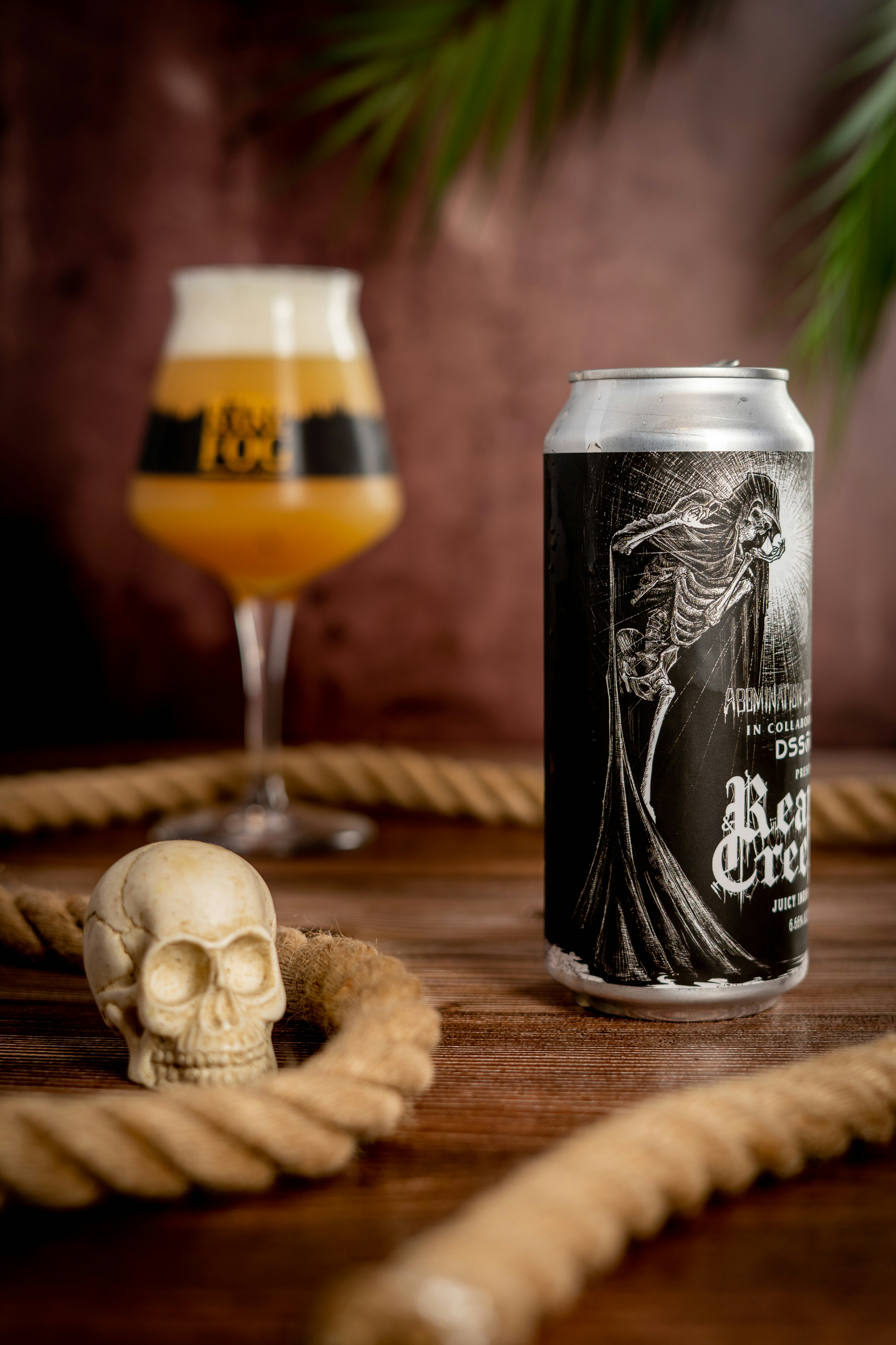 A glass of beer next to a skull and a skull on a table photo – Free ...