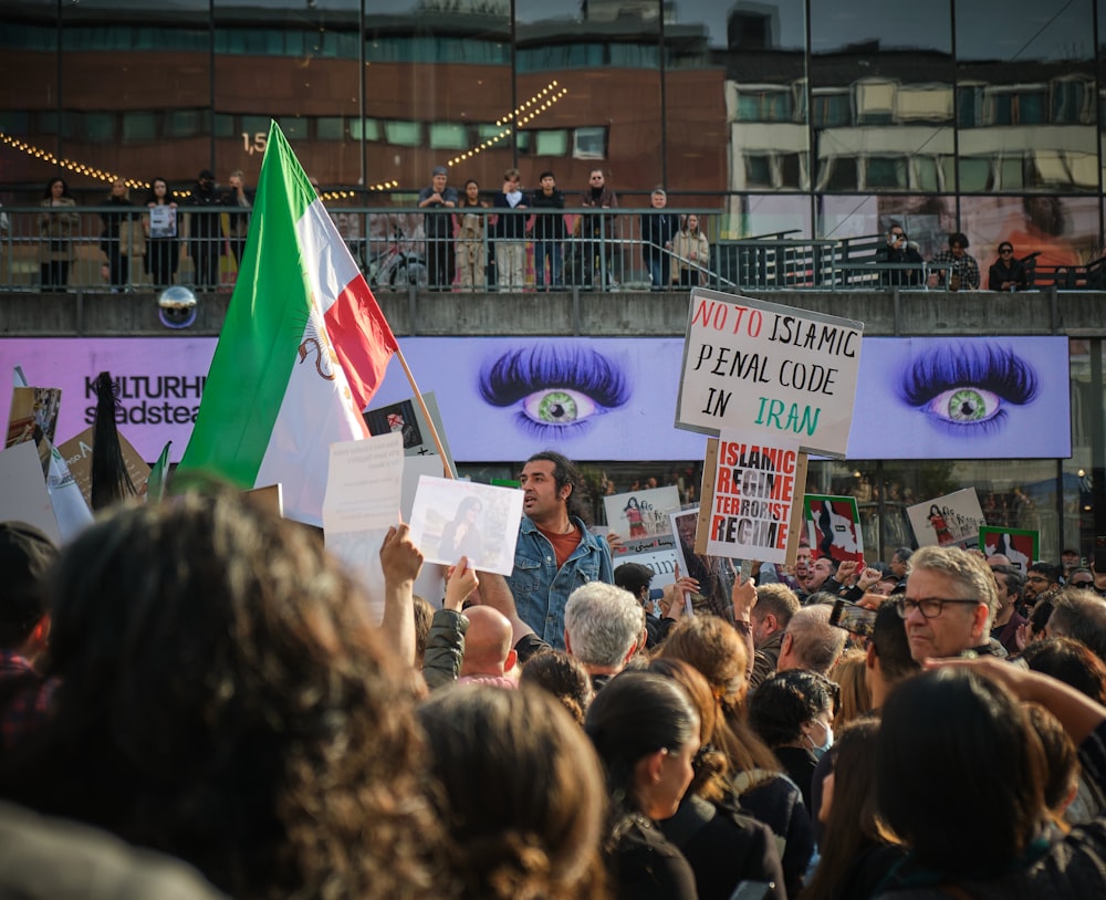 a group of people holding signs and flags