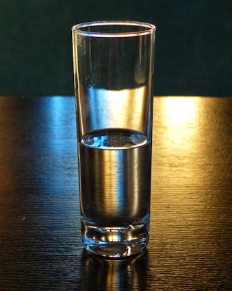 Steel and glass vessels filled with energizing water, bathed in soft evening light