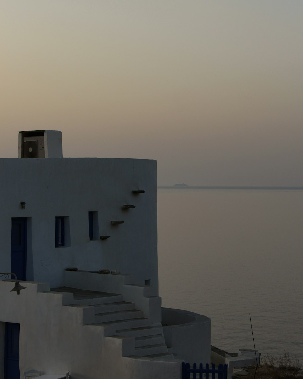 a building with stairs leading up to the water