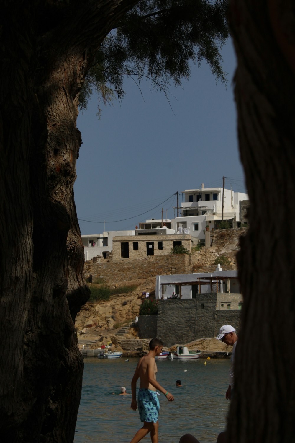 a person and a boy in a body of water by a building