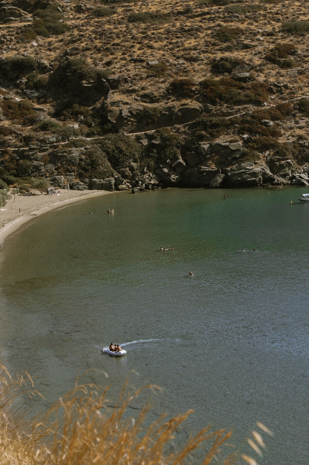 a beach with people swimming