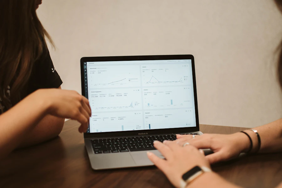 Two colleagues reviewing SEO performance data together on a laptop