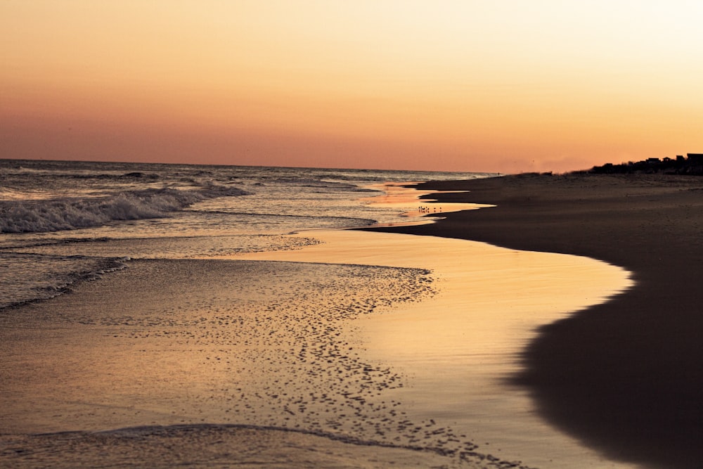 a beach with waves crashing on it