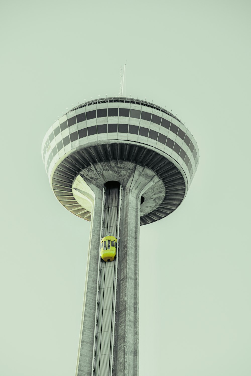 a tall tower with a yellow sign