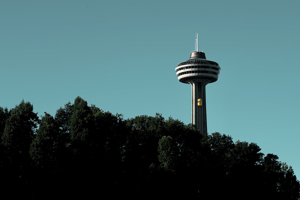 a tall tower with trees in the foreground