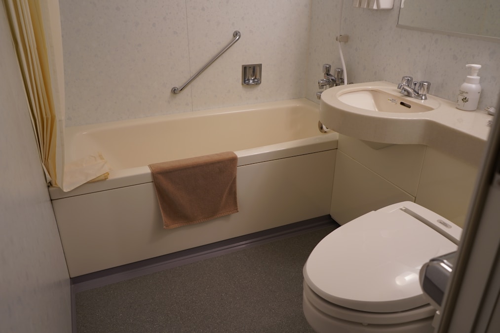 After: Clean modern bathroom with professional plumbing installation