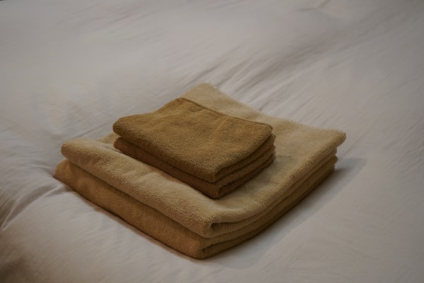 Clean folded towels on white linen