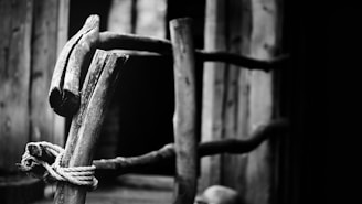 Close-up of a sturdy timber gate with bespoke design details in a rural setting.
