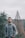 a man standing in front of trees