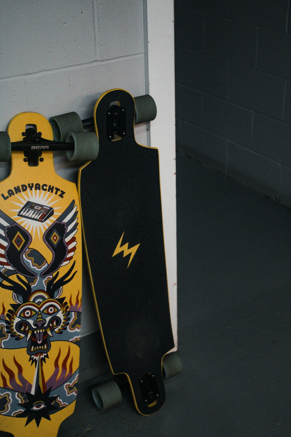 a couple of skateboards leaning against a wall