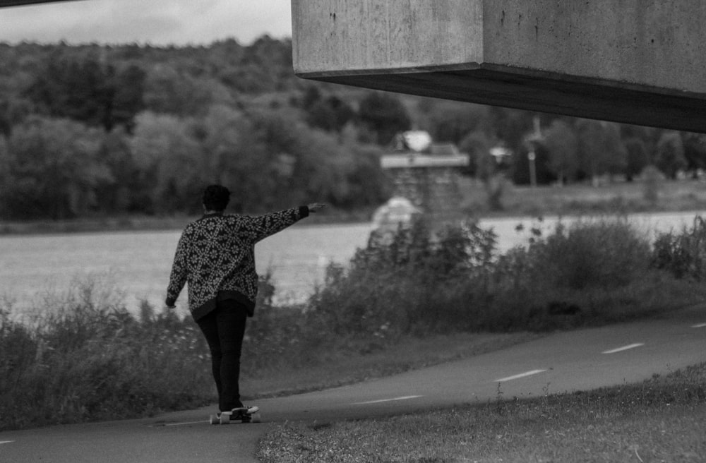 a person skateboards under a bridge