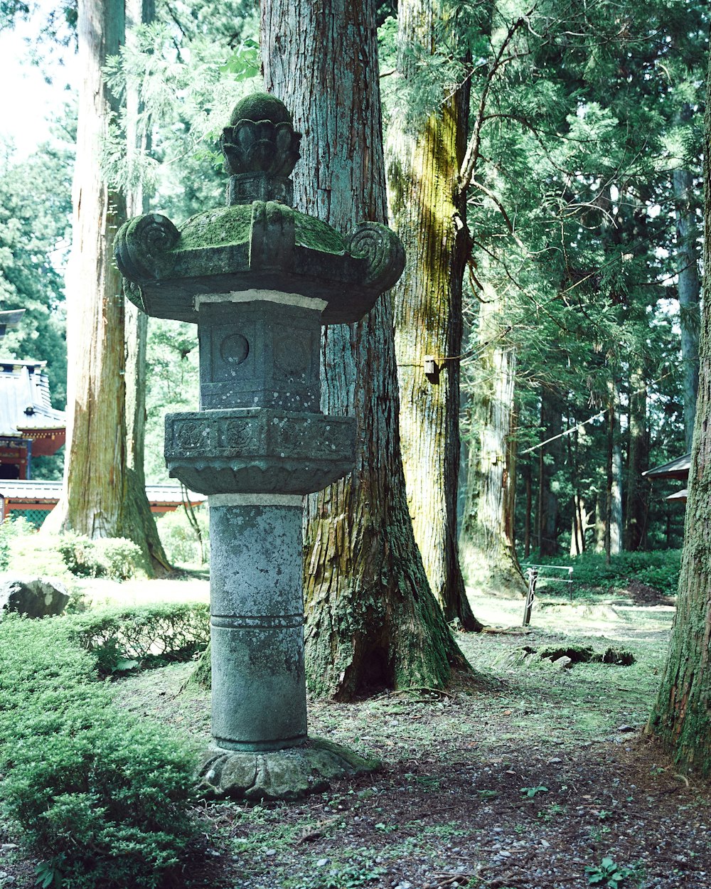 a statue of a person in a forest