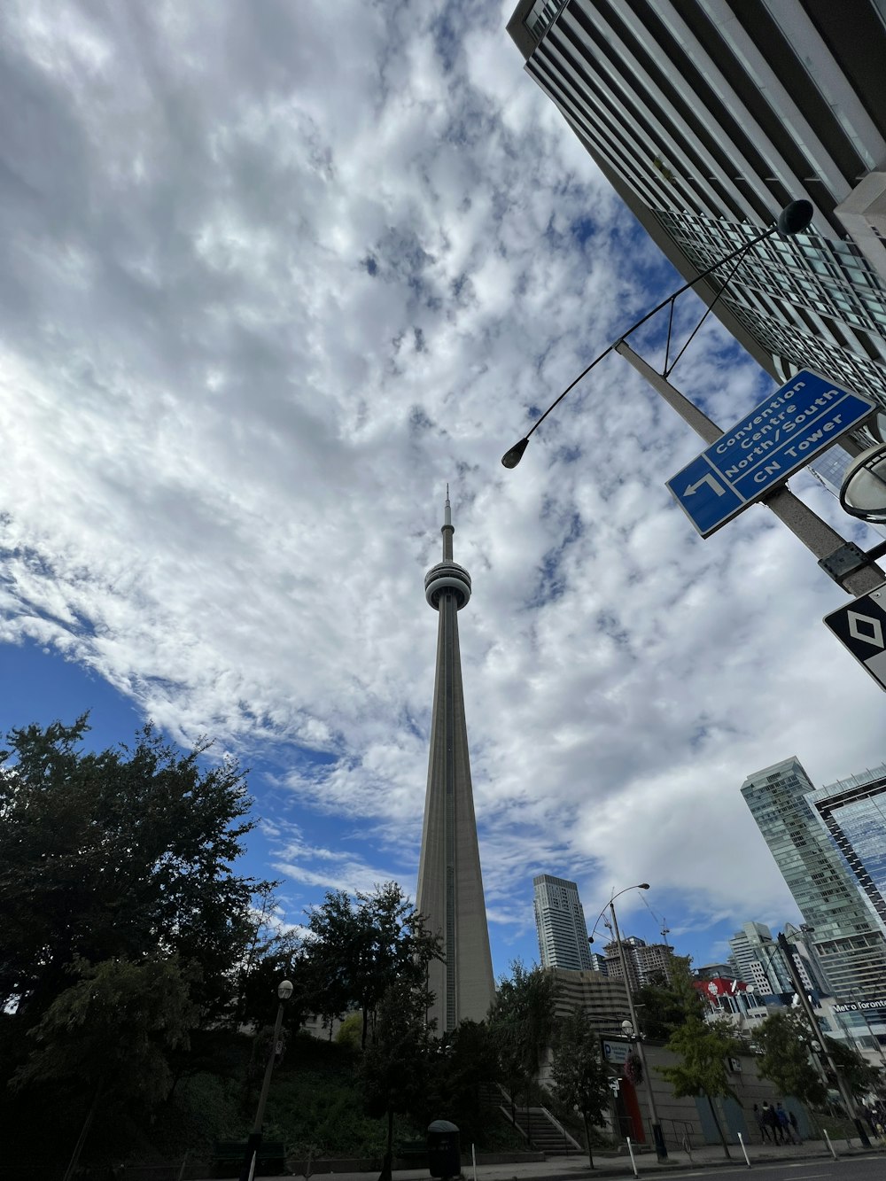 a street sign in front of a tall tower