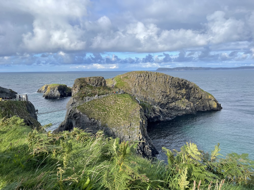 a rocky cliff with a body of water below