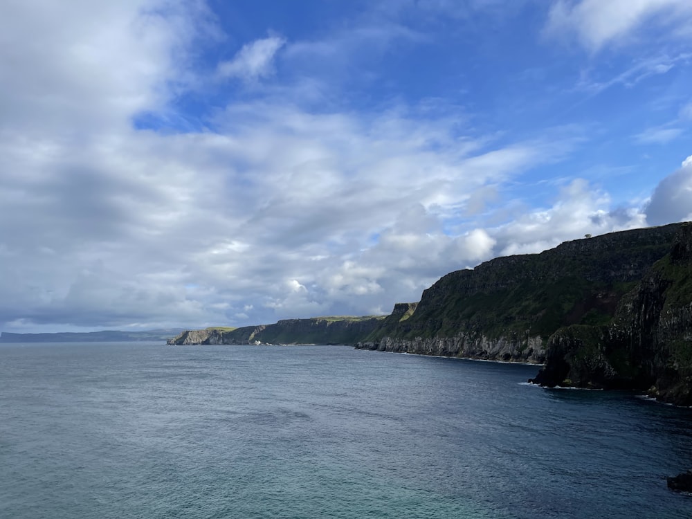 a body of water with hills in the back