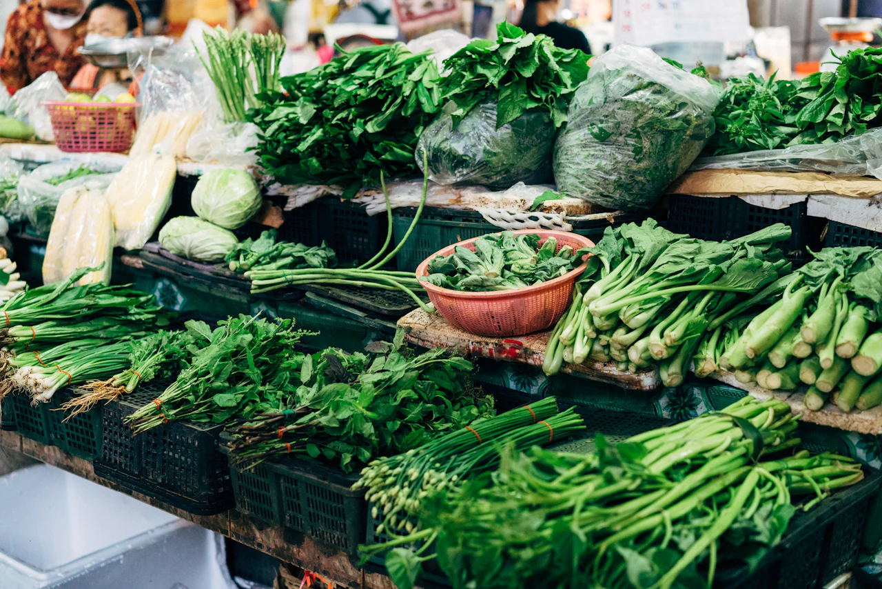 Fresh vegetables displayed in baskets at a Bangkok market