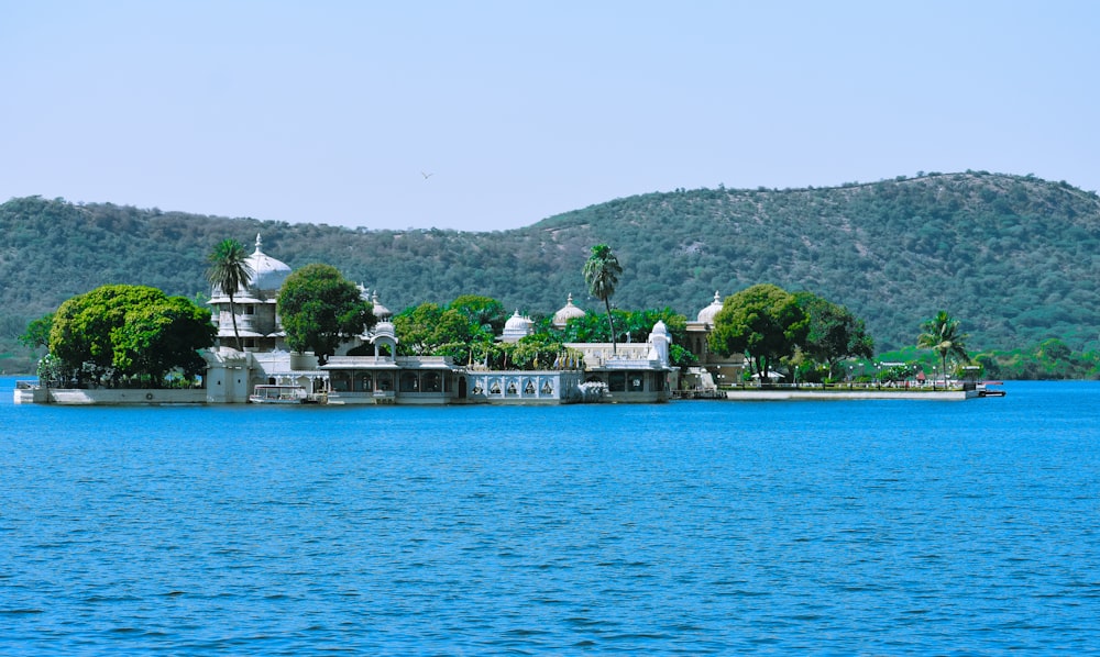 a body of water with buildings and trees on the side