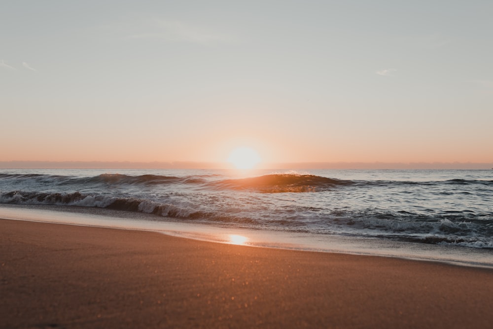 a beach with waves crashing on it