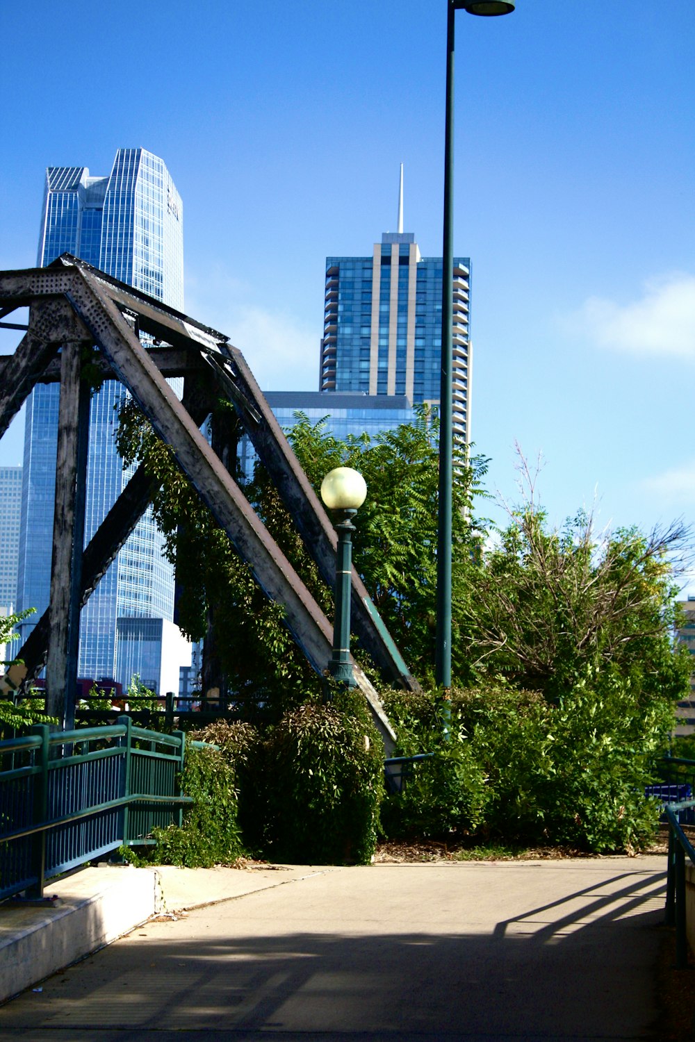 a walkway with trees and buildings in the background