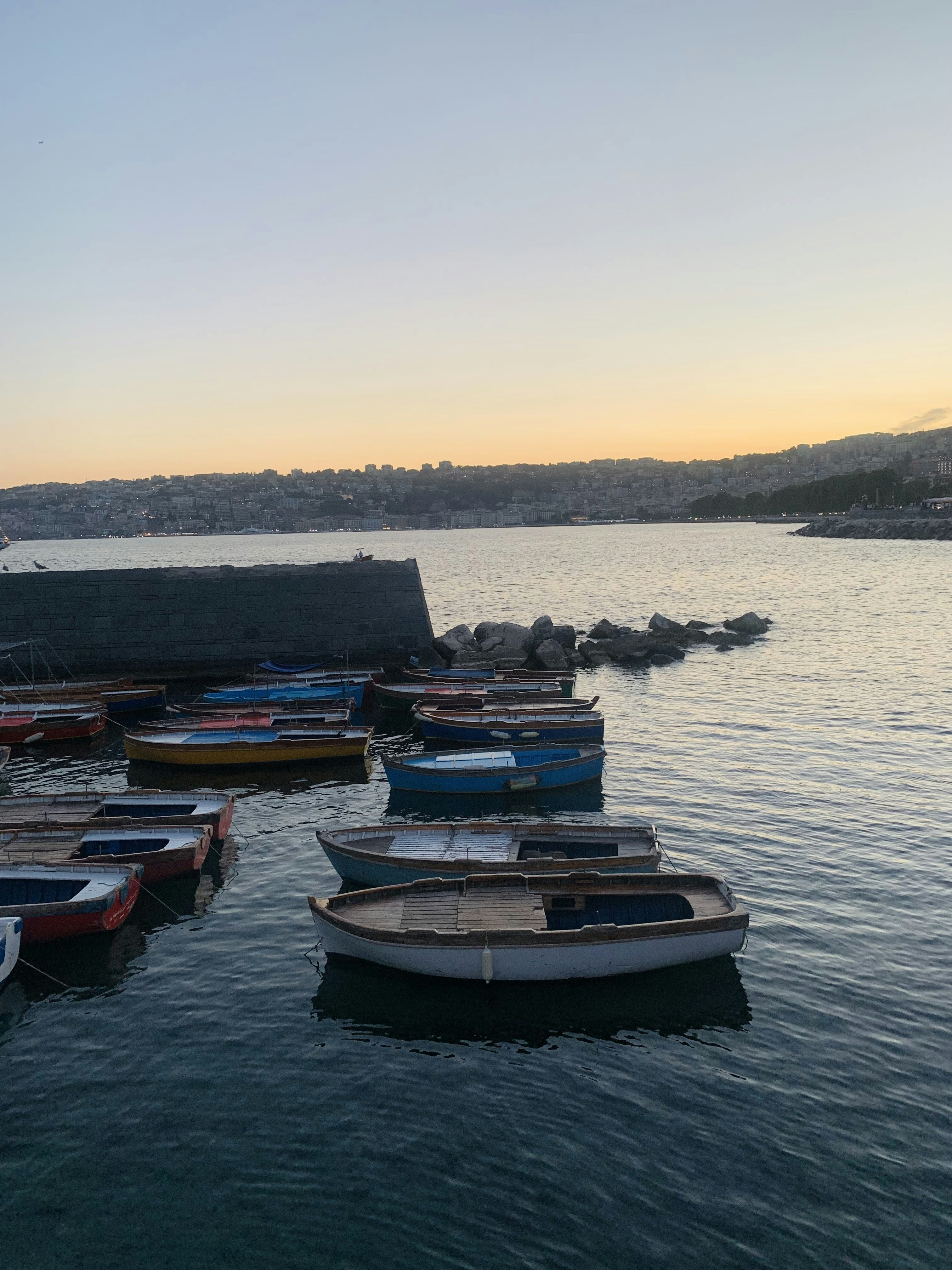 a group of boats sit in a harbor