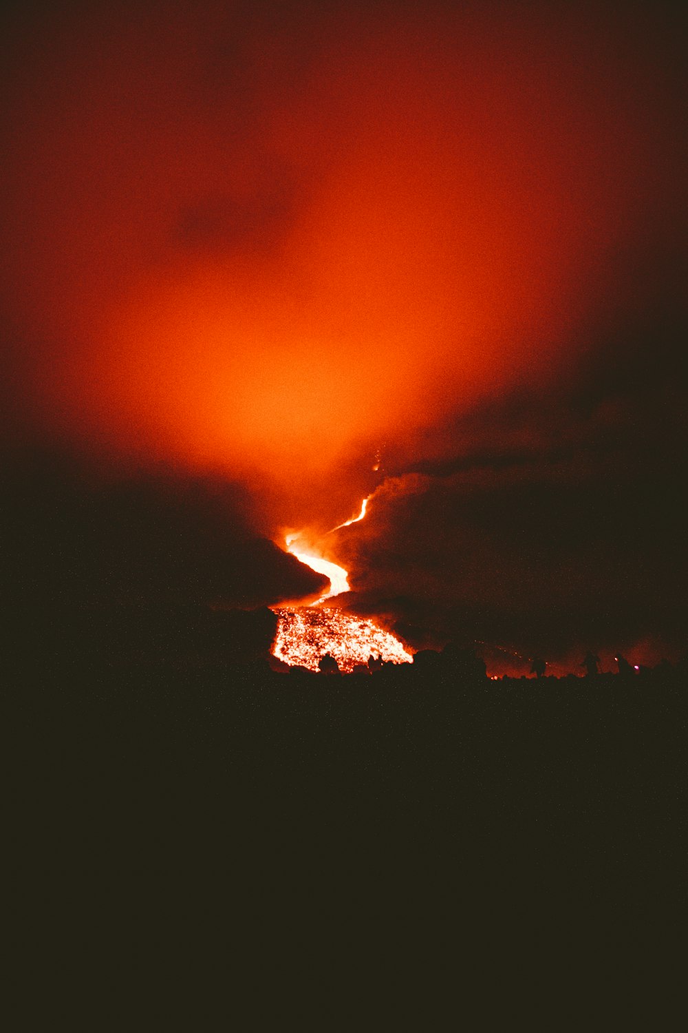 a volcano erupting at night