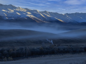 Soft morning light filtering through a serene Himalayan mountain landscape with subtle incense smoke rising.