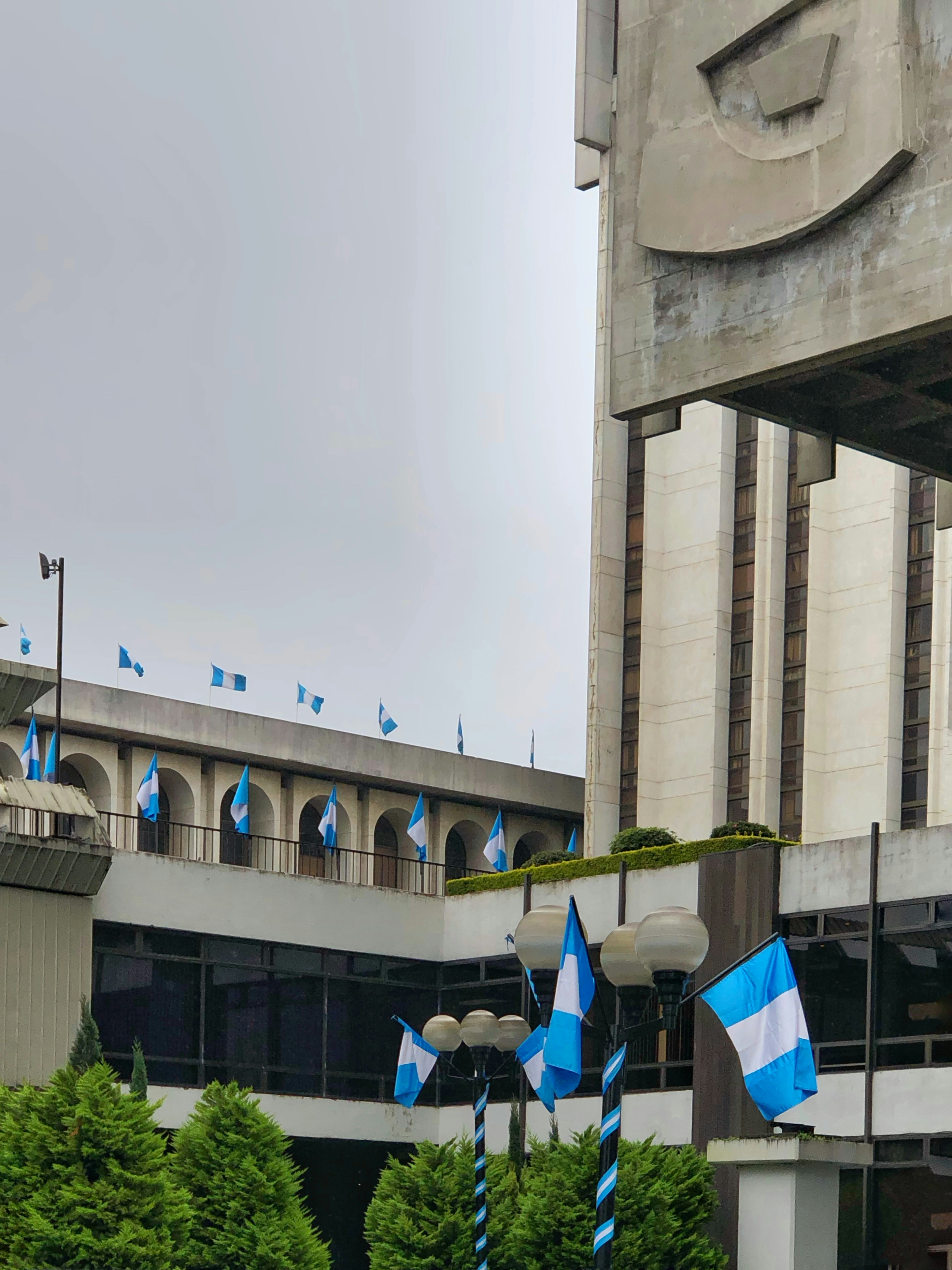 A group of flags in front of a building photo – Free City Image on Unsplash