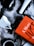 Several coffee cups and a bright orange book are placed on a marbled surface. The cups vary in color, with some being white and others black, and they are filled with black coffee. The book has bold text, suggesting themes of psychology and social change.