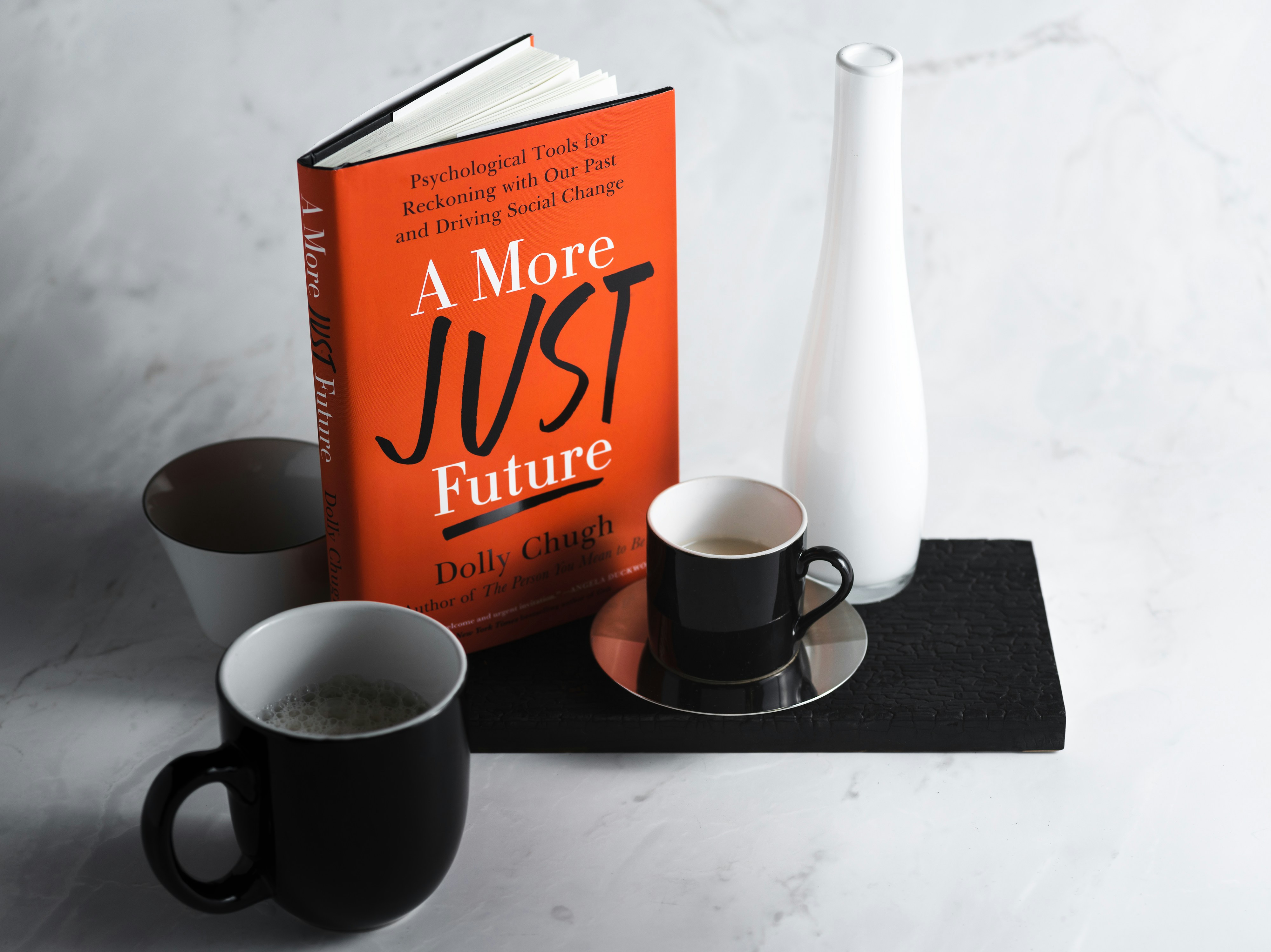 a box of coffee and a couple of mugs on a table