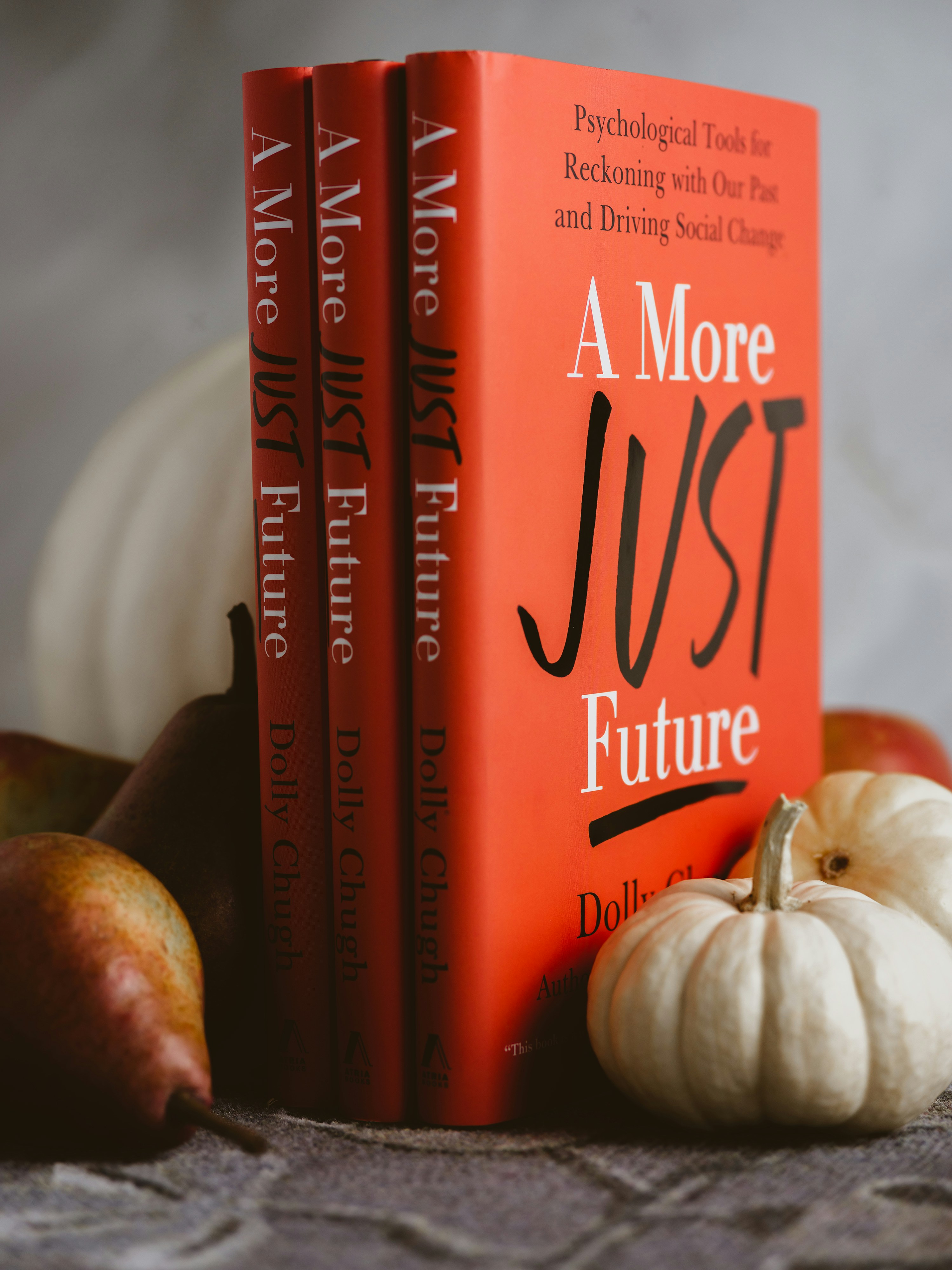 a book next to a couple of apples