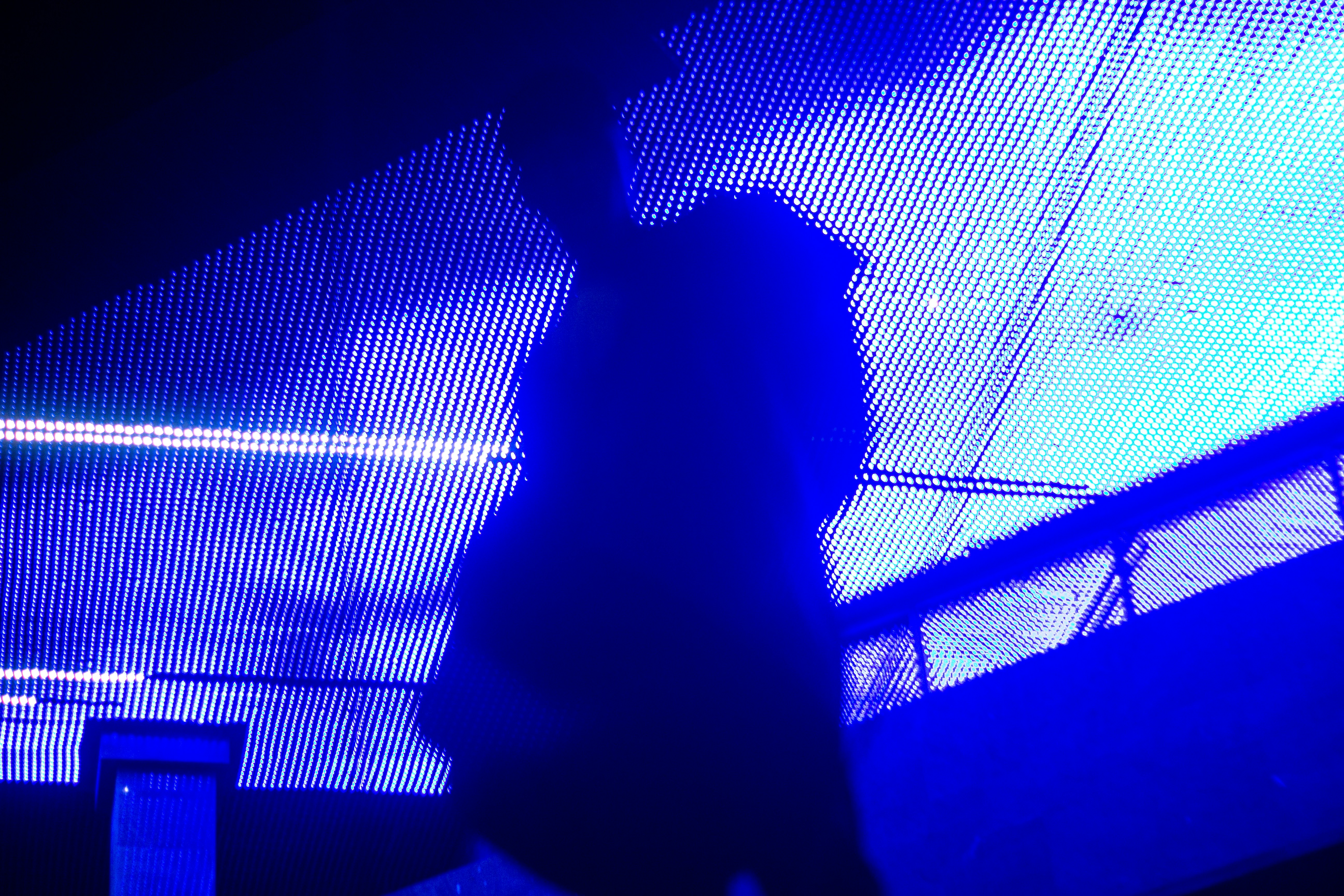 a person's shadow on a blue background