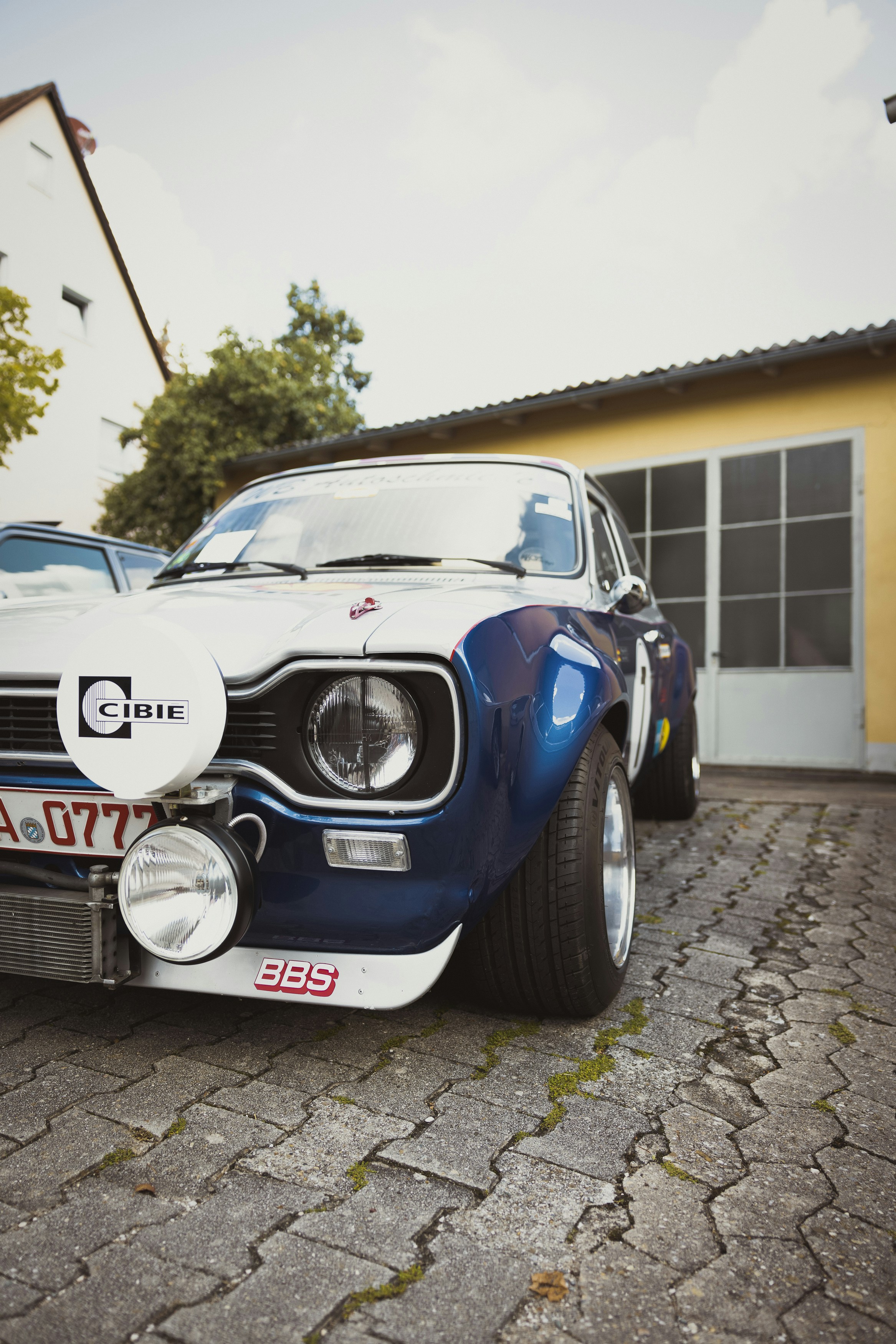 a blue car parked outside a building