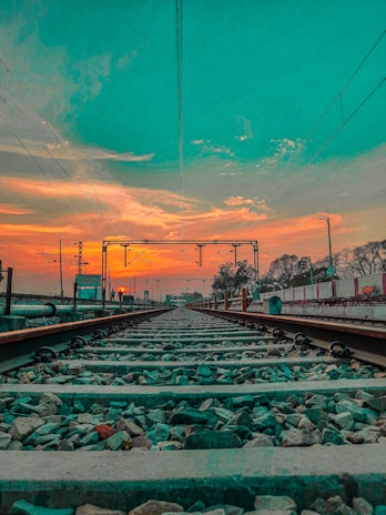 A panoramic view of a railway yard during sunset.