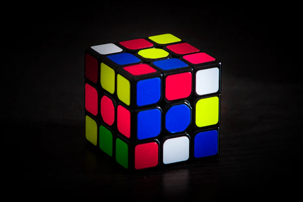 A vibrant close-up of a solved classic Rubik's Cube with bright red, blue, and yellow squares.