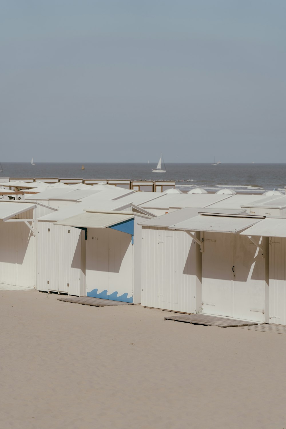 a group of white buildings on a beach