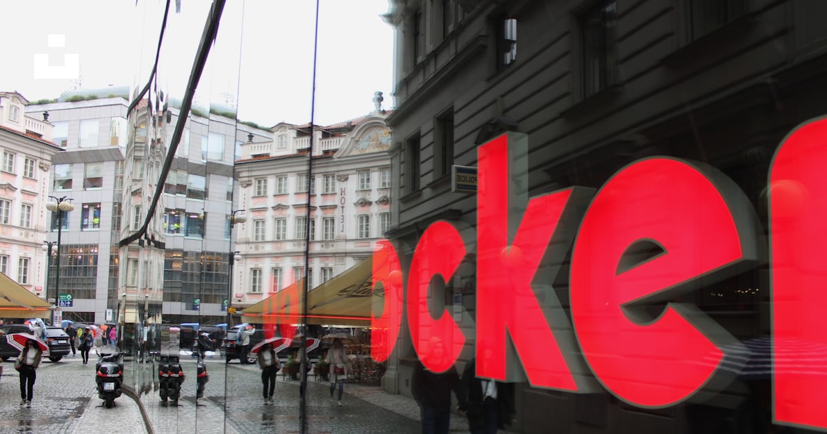 A large red sign on a building photo – Free Reflection Image on Unsplash