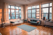 Spacious living room with modern decor and large windows letting in natural light.
