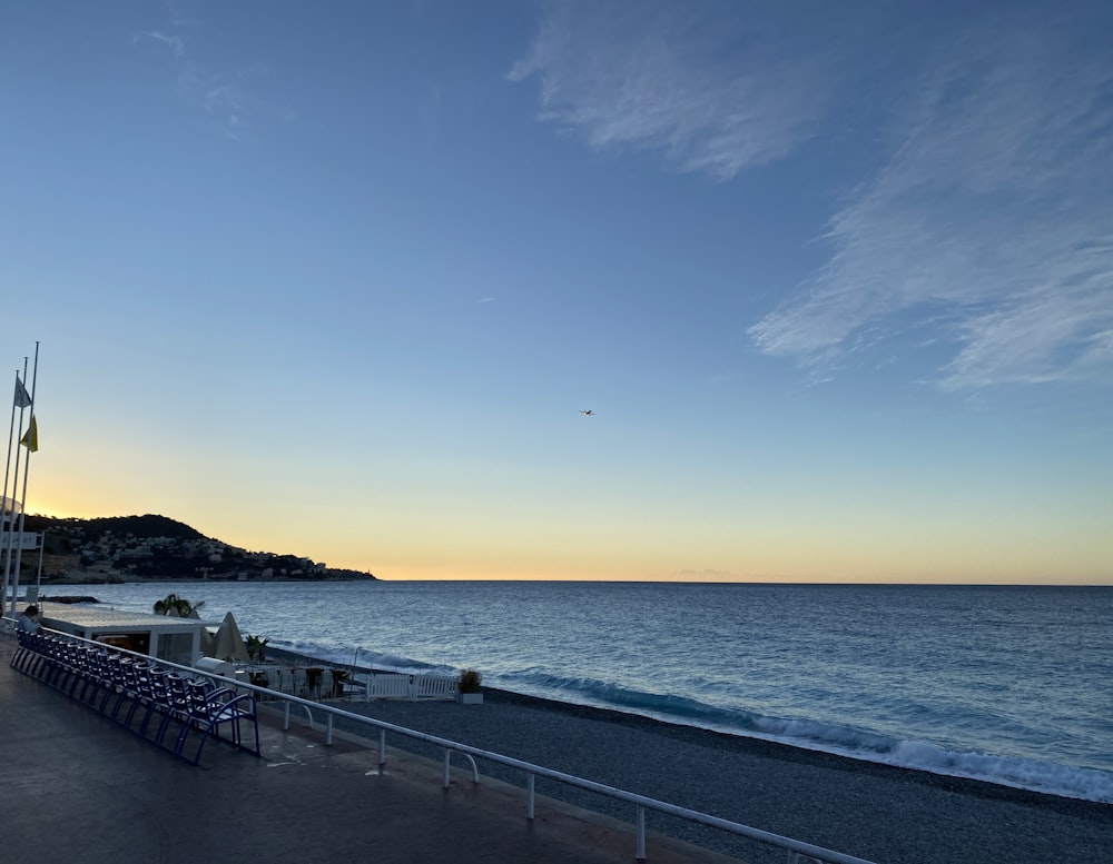 a body of water with a walkway and a railing by it