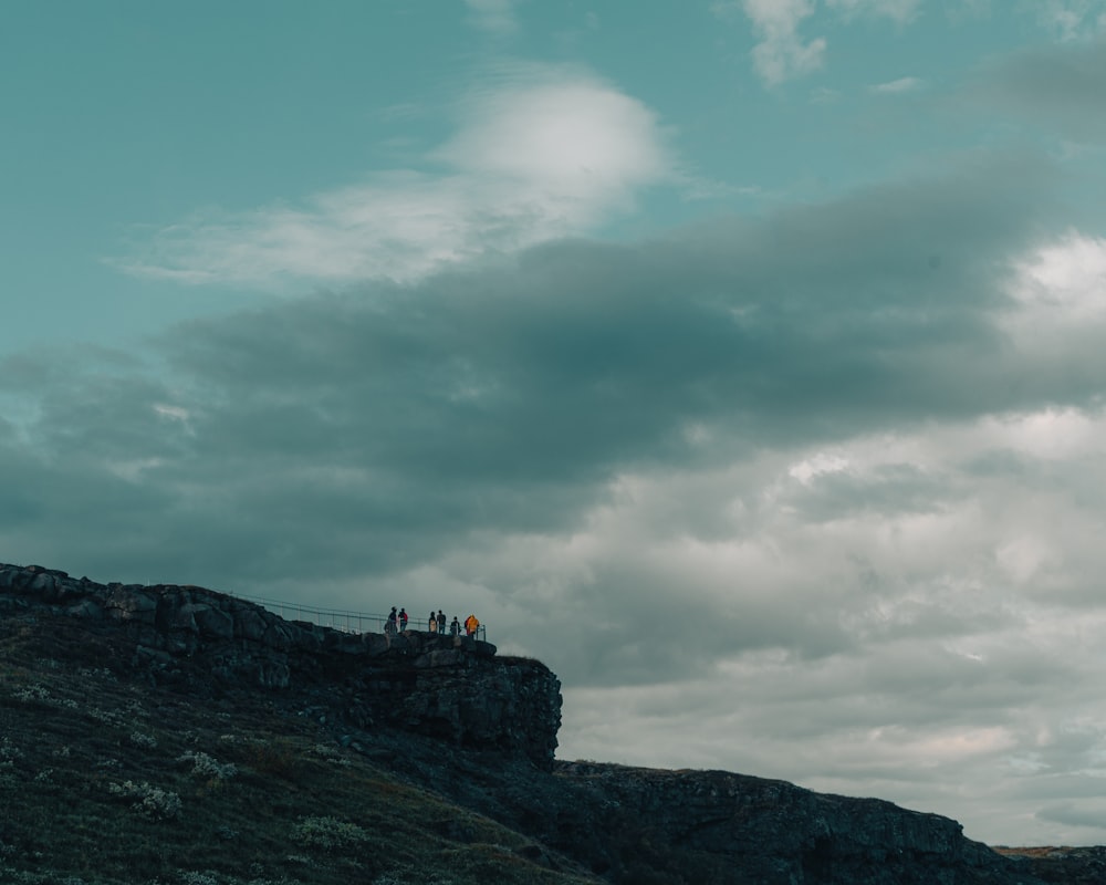 a group of people on a rocky hill