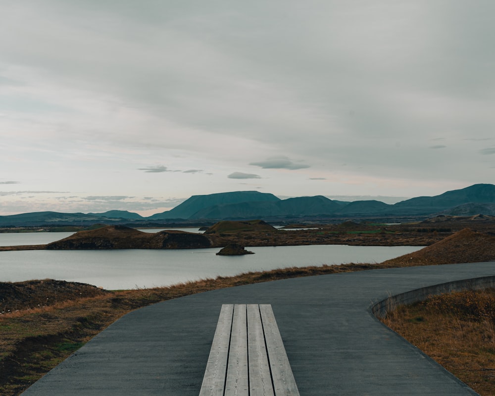 a road next to a body of water