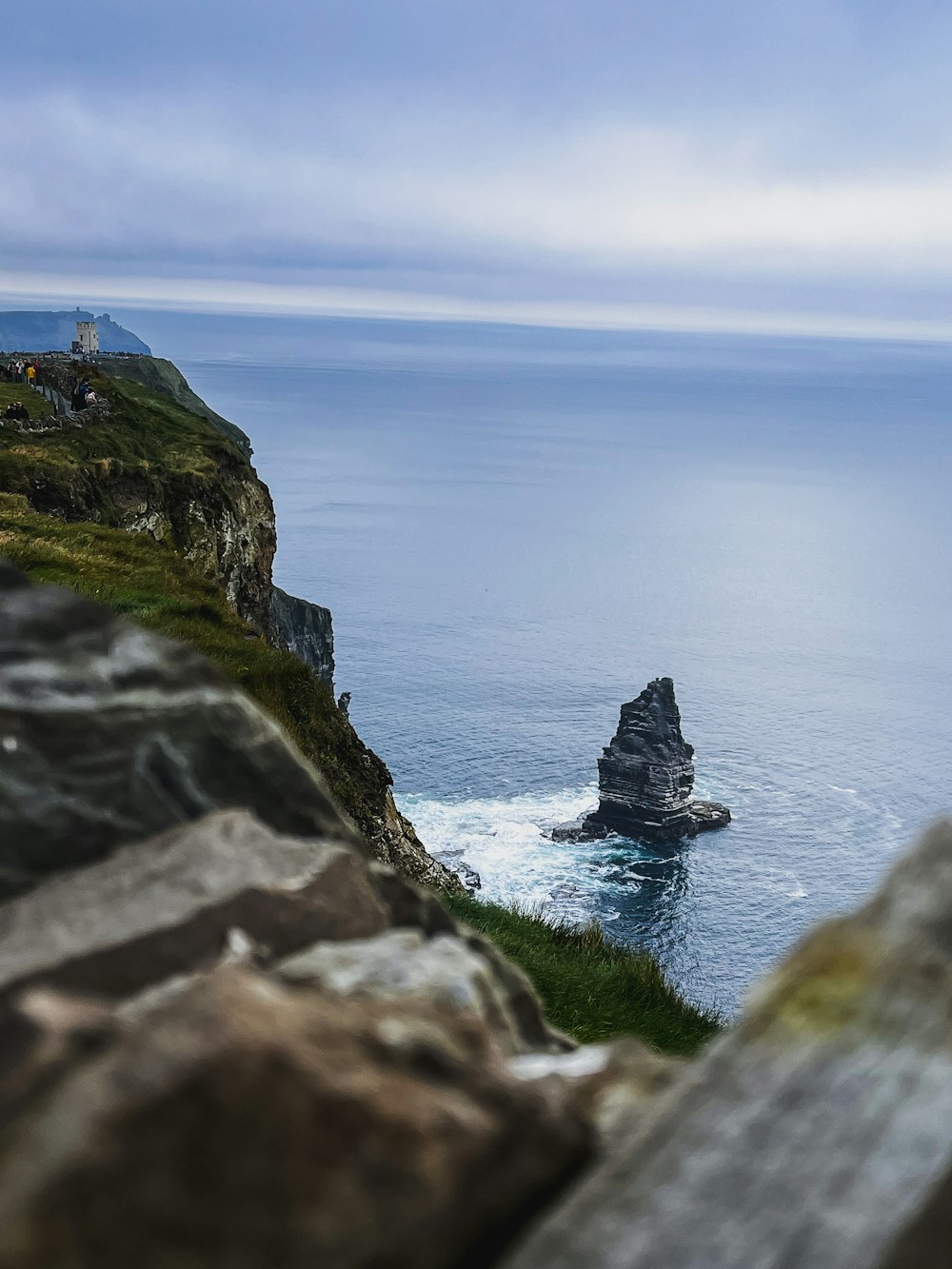 a rocky cliff overlooking a body of water