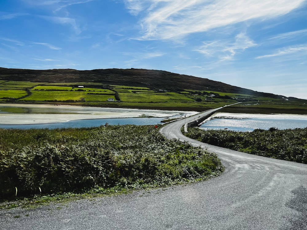 a road next to a body of water