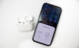 AirPods being tested for sound quality after a battery replacement.