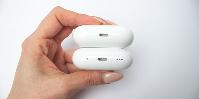 a hand holding a white game controller