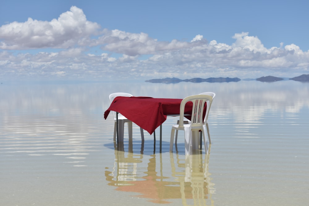 a chair and a table on a beach