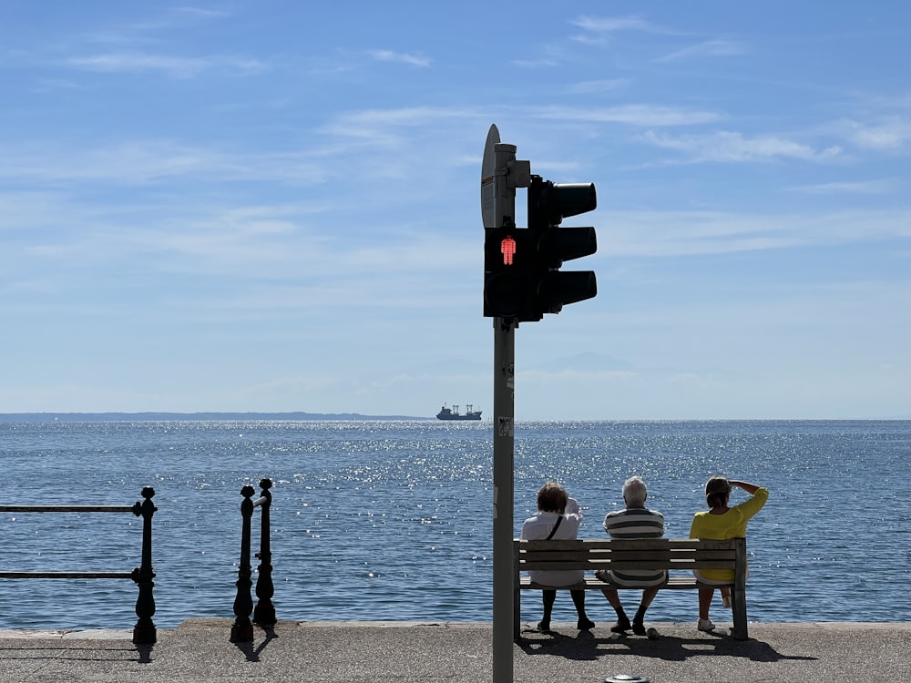 people sitting on benches at a stop light